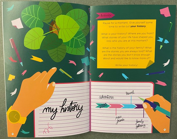 "This Book is Anti-Racist" by Tiffany Jewel is open to a full spread opened to an illustration by Aurelia Durand showing an image of a desk with a person's hands holding a pen and notebook and following directions and prompts listed there for the reader to explore and reflect on their personal history.