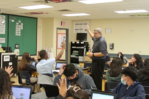 Science teacher Steven Humble, NBCT, gestures as he teaches a room full of eighth-grade science students.