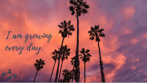 The words "I am growing every day." are in a gray script font over a photo of a pinkish-purple cloudy sky and palm trees rising in the sky.