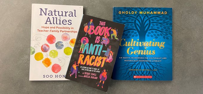 Copies of "Natural Allies" by Soo Hong, "This Book is Anti-Racist" by Tiffany Jewell , and "Cultivating Genius" by Gholdy Muhammad are displayed next to each other.