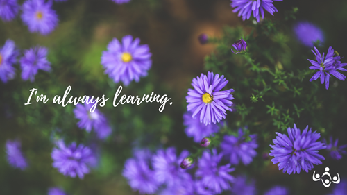 The words "I'm always learning." are in white script over an image of purple flowers and their green foilage.